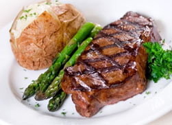 correctly grilled new york strip, by apprentice cook, the fat side is facing the customer, this should not be served in a Fine Dining Restaurant